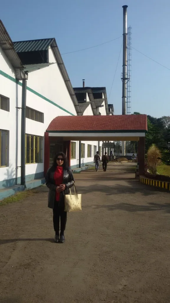 Lady standing in front of Upper Assam tea factory building