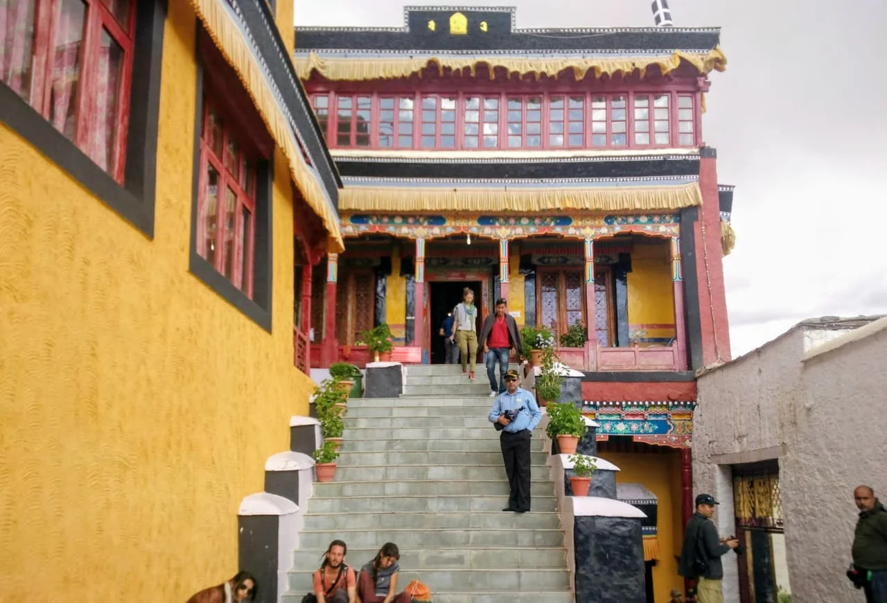 Visitors at the entrance of a traditional Buddhist monastery in Leh, Ladakh.