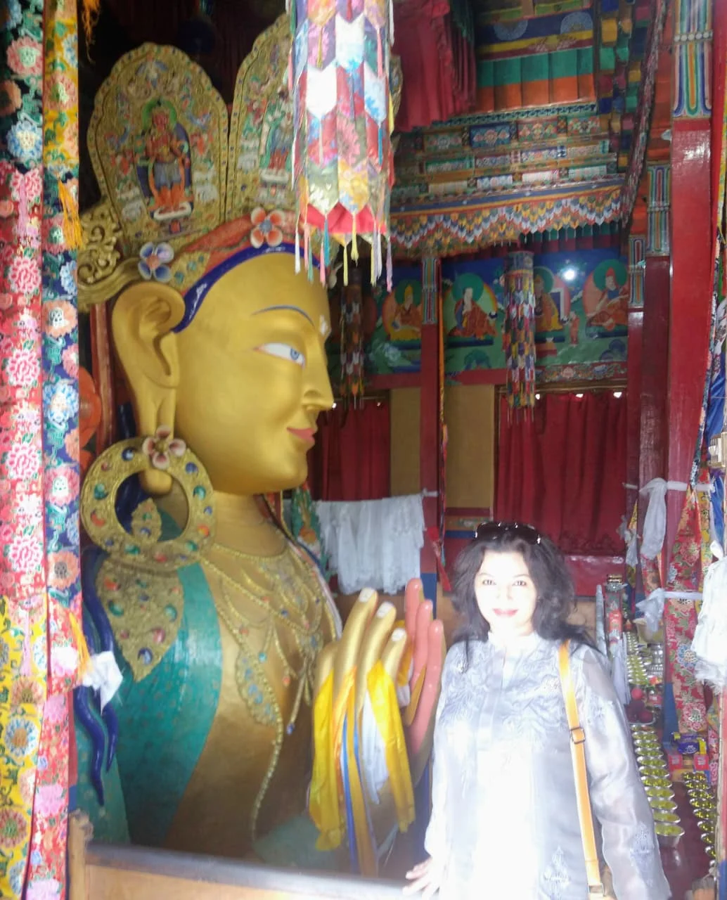 A large Buddha statue inside a traditional Buddhist monastery in Ladakh.
