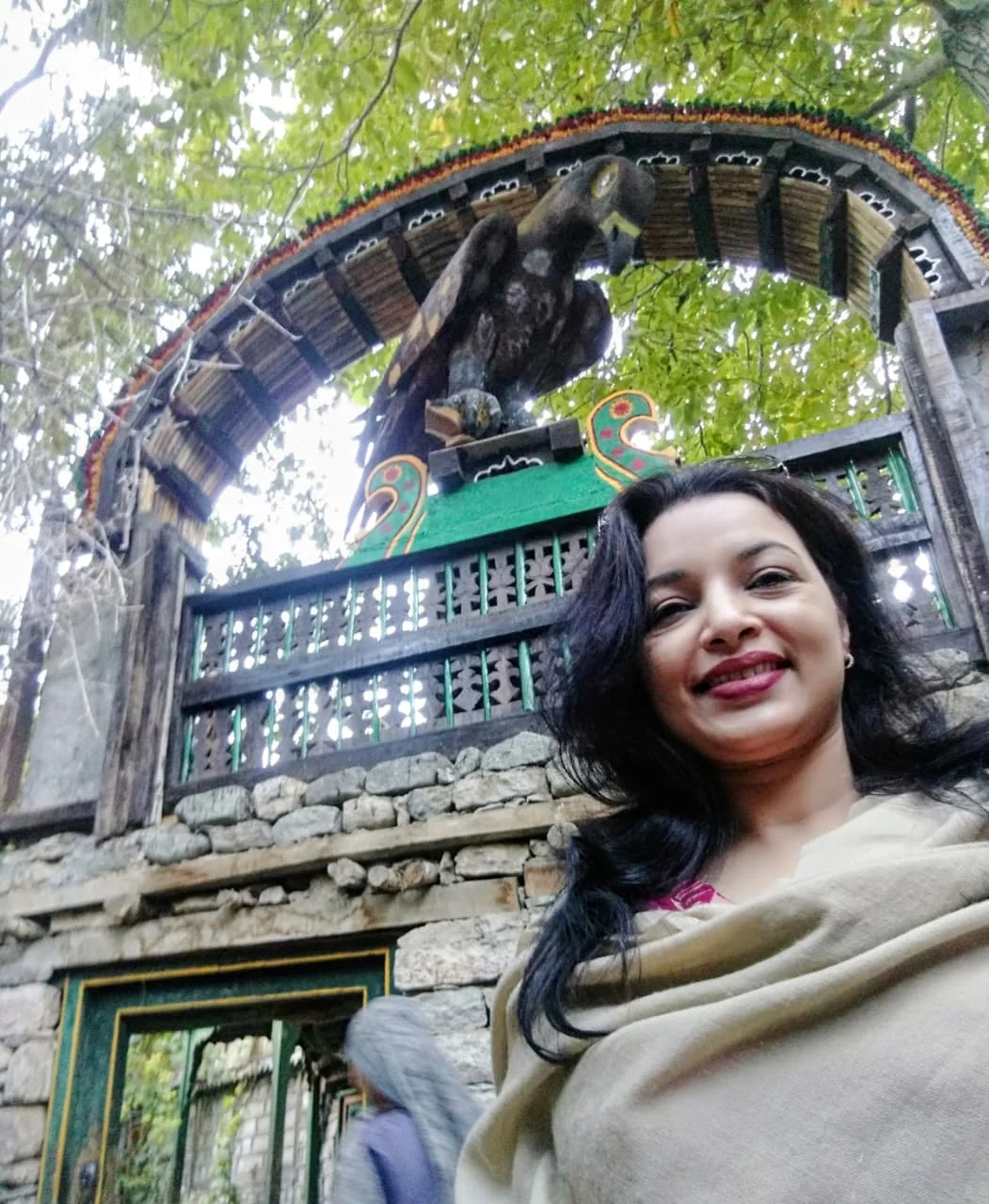 At a traditional wooden gate in Turtuk village.