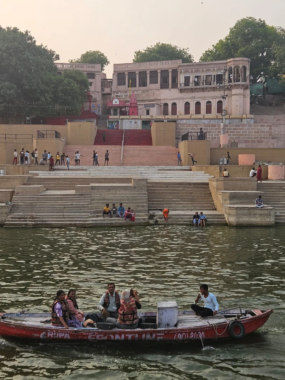 The massive red sandstone fortification walls and towers of Chet Singh Fort at the water's edge