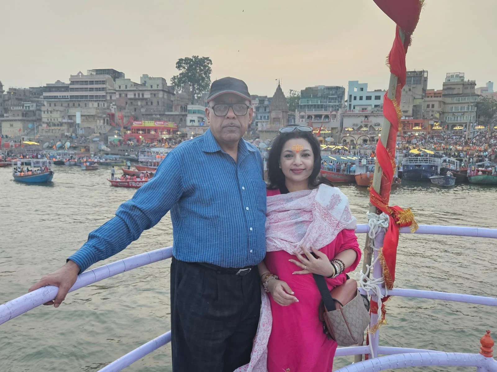 Traditional structures and colorful flags adorning the steps of Dashashwamedh Ghat