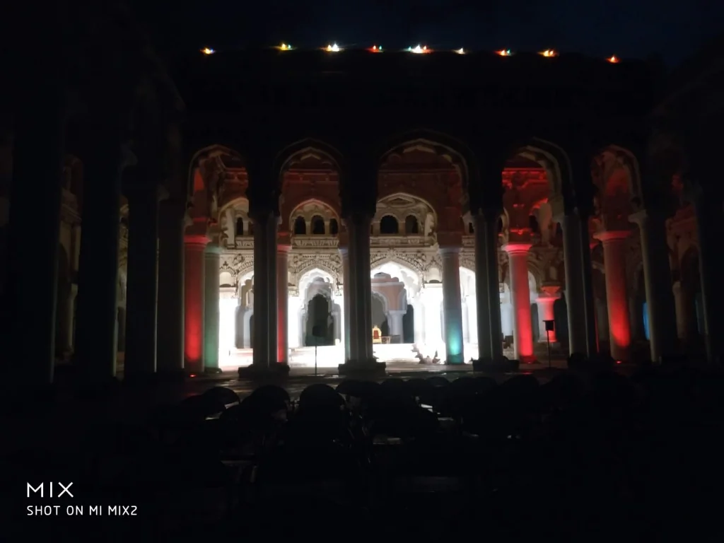 Dramatic evening illumination of grand arches during the Light and Sound Show at Thirumalai Nayakkar Palace