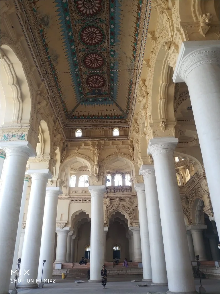 Soaring white pillars and painted ceiling corridor of Thirumalai Nayakkar Palace