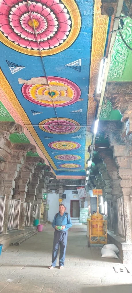 Intricately painted lotus mandala ceiling in the temple corridor