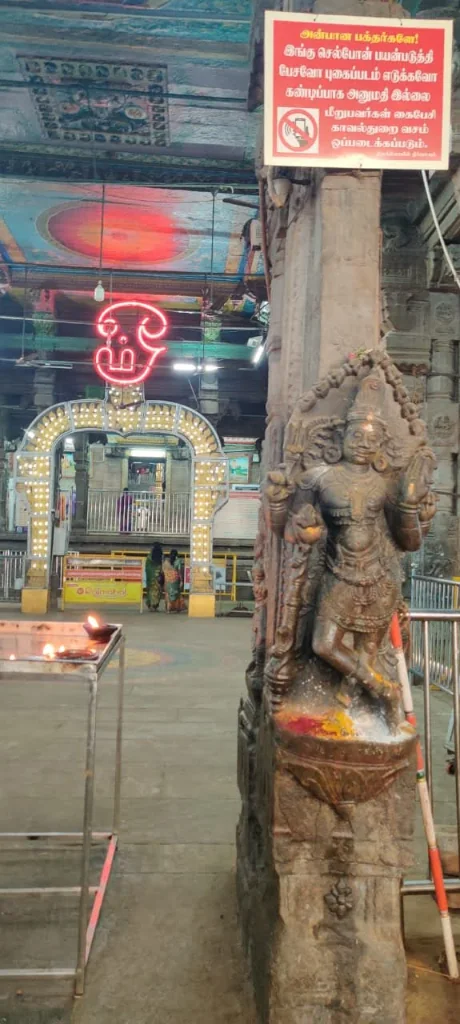 Sculpted deity shrine pillar and archway inside temple complex