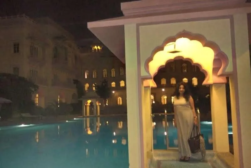 Night view of an illuminated pavilion and pool at Taj Hari Mahal in Jodhpur