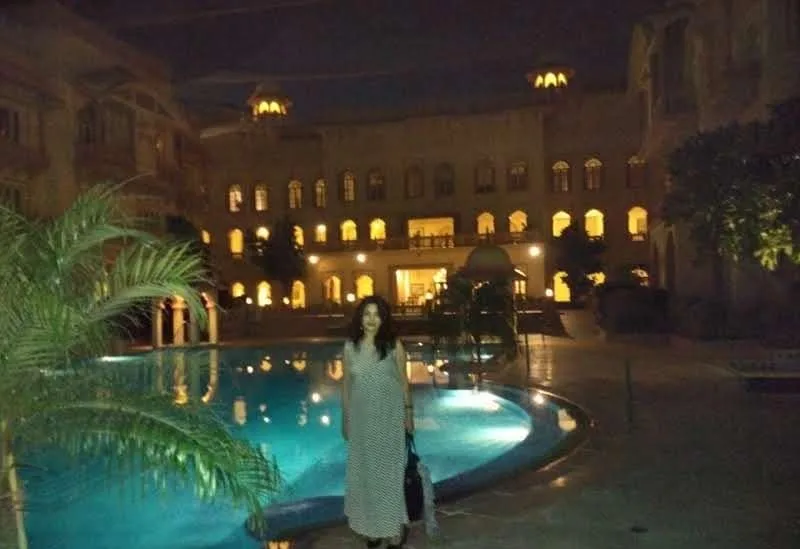 Illuminated heritage-style hotel pool courtyard at night in Jodhpur