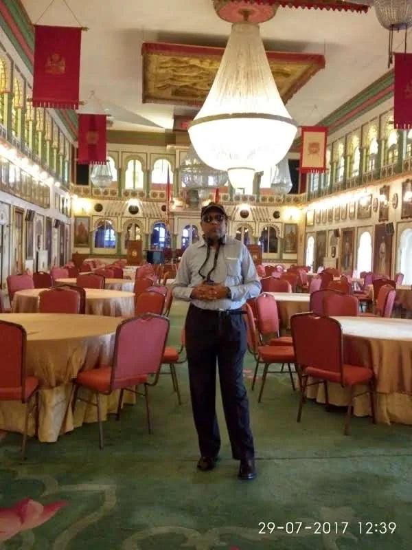 Massive central crystal chandelier suspended from the high ceiling of Durbar Hall in Udaipur City Palace