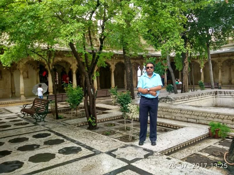 Peaceful shaded palace garden courtyard surrounded by stone paving and marble fountains