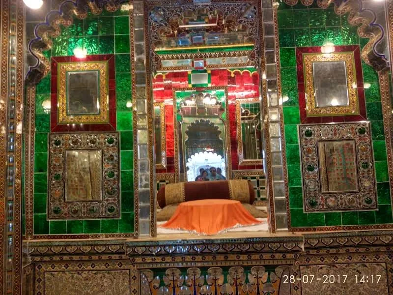 Intricate green and red Belgian glass inlay panels and mirror work inside Sheesh Mahal at Udaipur City Palace